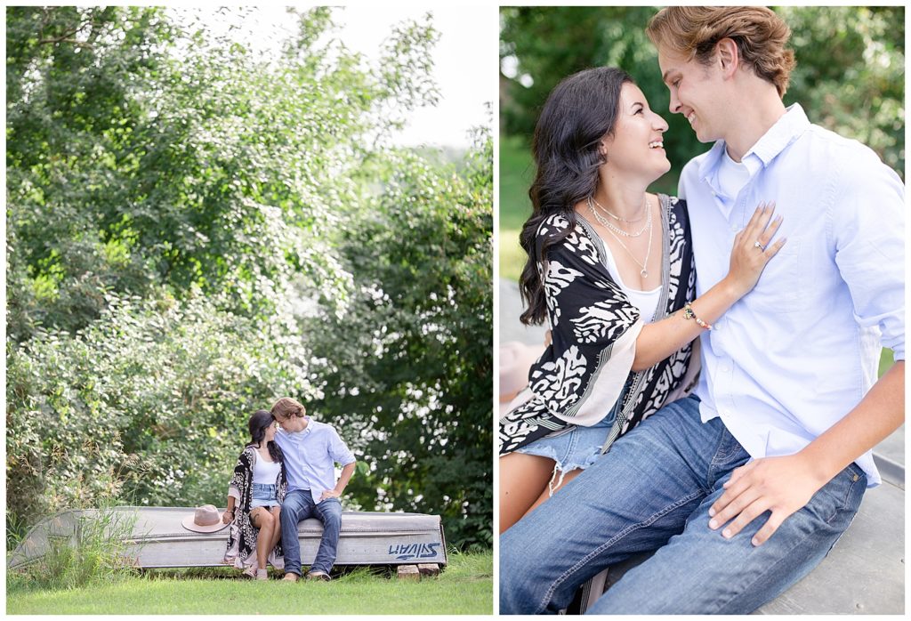 Couple smiling at each other while sitting on a boat at Wall Lake, South Dakota during engagement session at sunset
