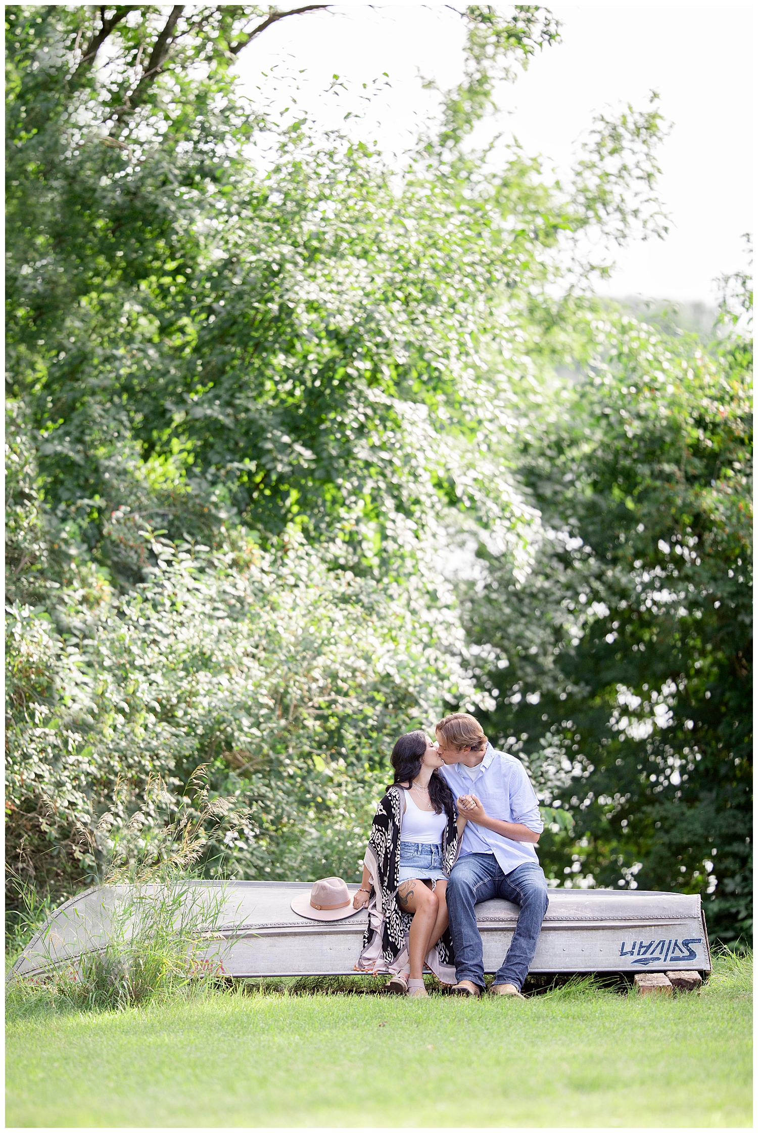 Couple walking together at Wall Lake, South Dakota during engagement session at sunset