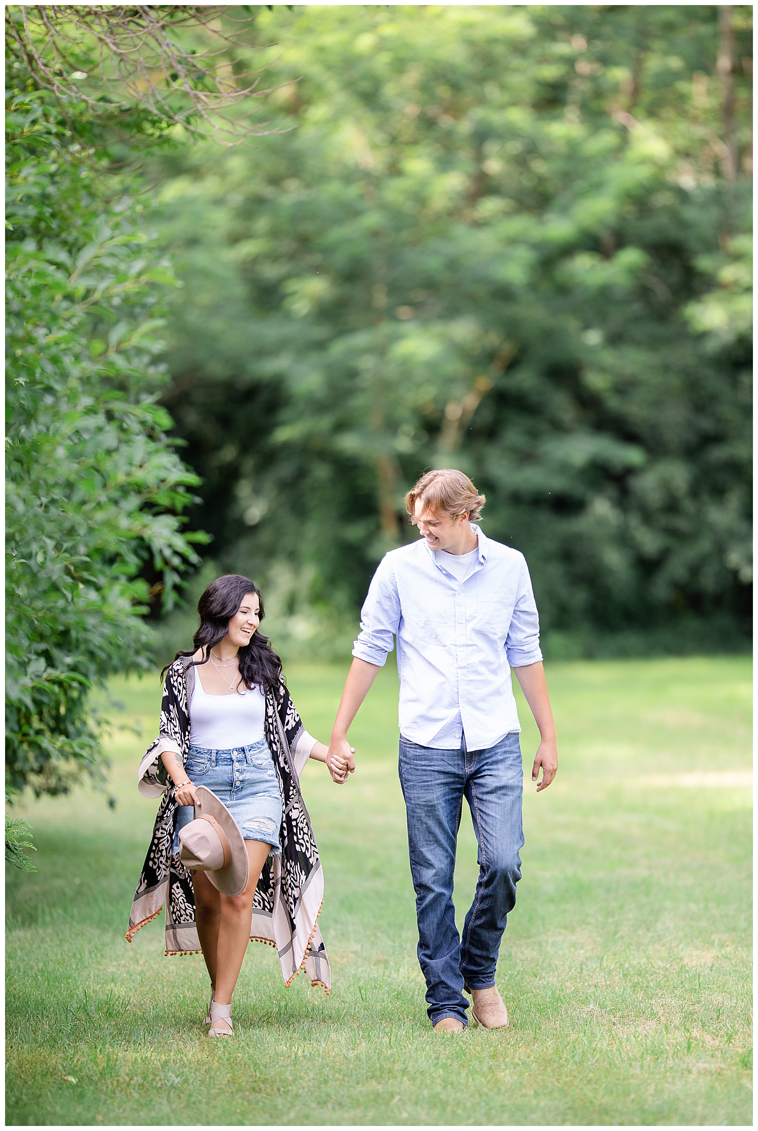 Couple walking together at Wall Lake, South Dakota during engagement session at sunset