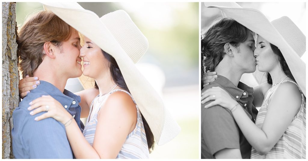 Couple kissing under hat at Wall Lake, South Dakota during engagement session at sunset
