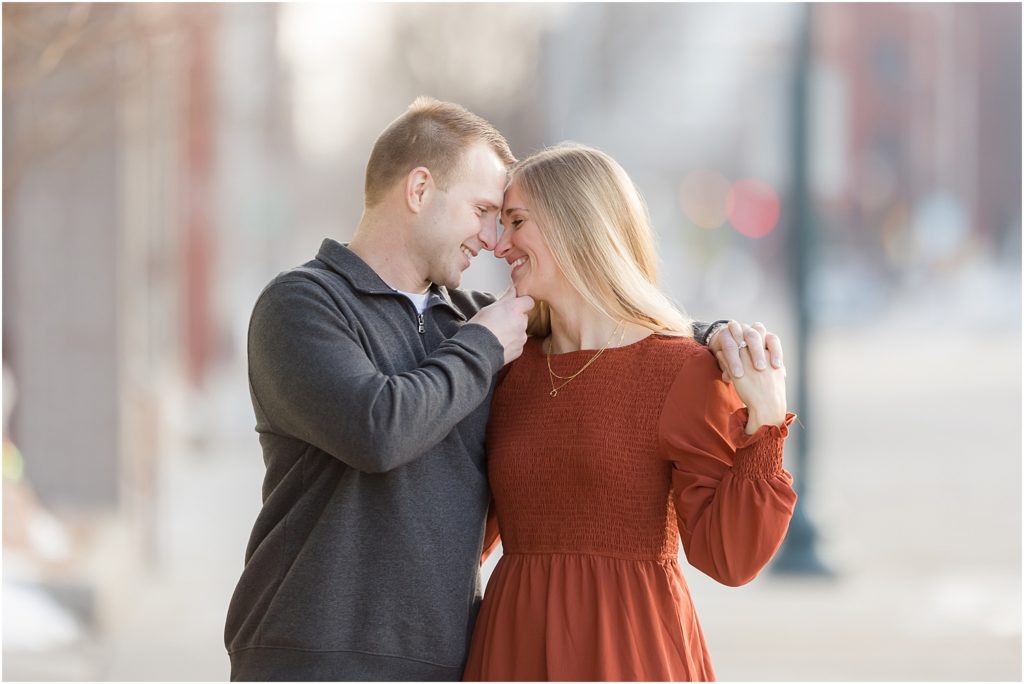 Engaged couple walking Downtown Sioux Falls during winter