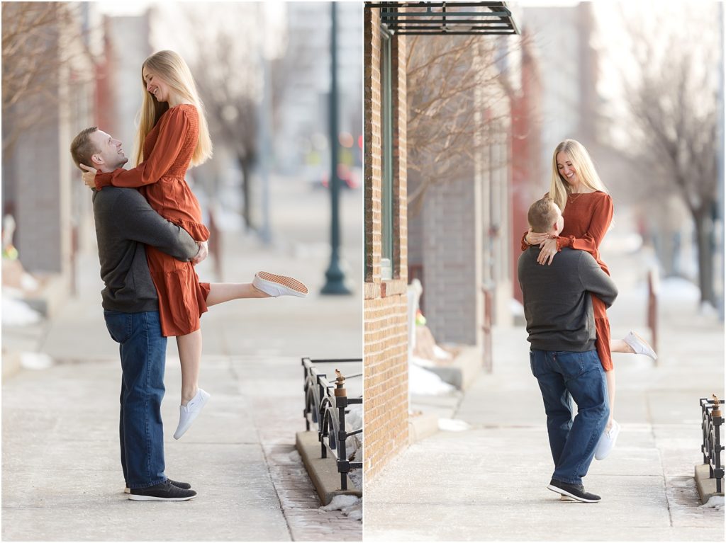 Engaged couple walking Downtown Sioux Falls during winter