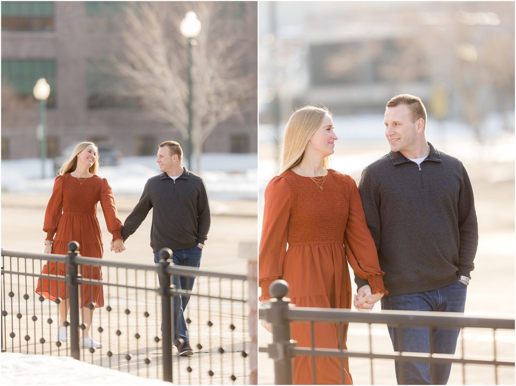 Engaged couple walking Downtown Sioux Falls during winter