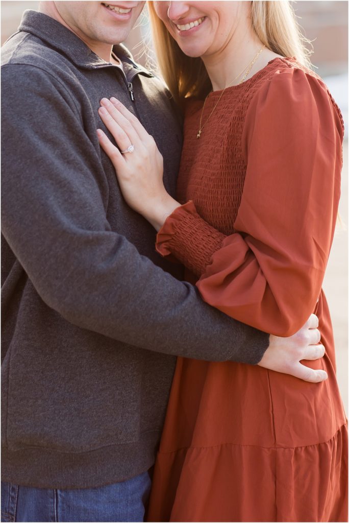 Engaged couple walking Downtown Sioux Falls during winter