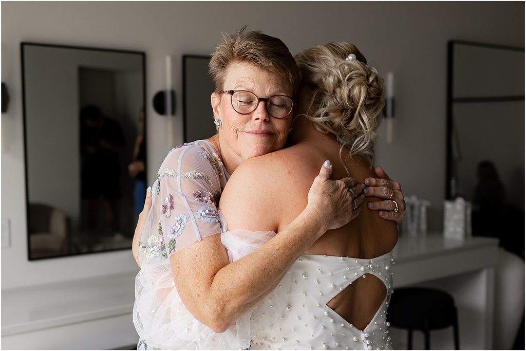 Bride hugging her mom at Monick Yards, Sioux Falls, SD. Luxury Wedding Photographer Sioux Falls, SD