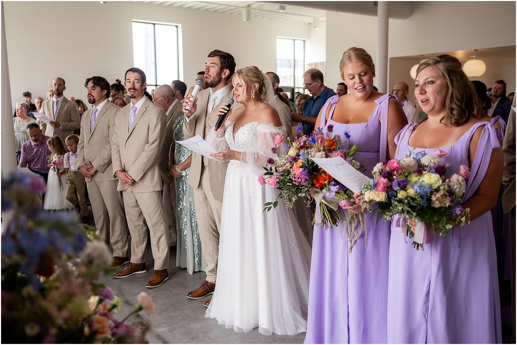 Bride and groom sing during their wedding ceremony at Monick Yards wedding venue. Sioux Falls, SD
