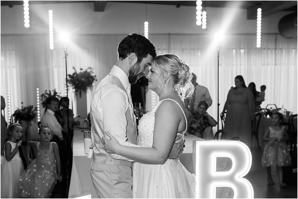 Bride and groom dancing during their wedding reception at Monick Yards wedding venue. Sioux Falls, SD. Summer wedding.